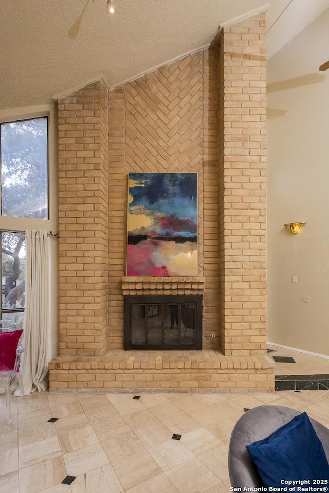 living room featuring a textured ceiling, lofted ceiling, tile patterned floors, a fireplace, and ceiling fan