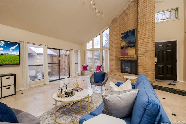 living room featuring high vaulted ceiling, a textured ceiling, light tile patterned floors, and a brick fireplace