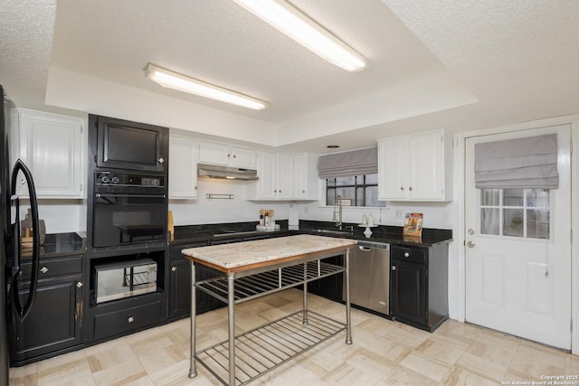 kitchen with black appliances, a raised ceiling, and a textured ceiling