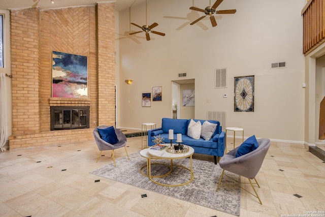 tiled living room with a brick fireplace and a towering ceiling