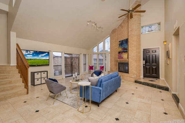 living room with high vaulted ceiling, light tile patterned floors, ceiling fan, and a fireplace