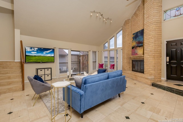 living room with a fireplace, light tile patterned flooring, and high vaulted ceiling