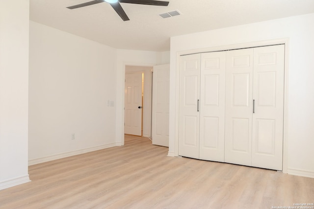 unfurnished bedroom featuring light wood-type flooring, a closet, and ceiling fan