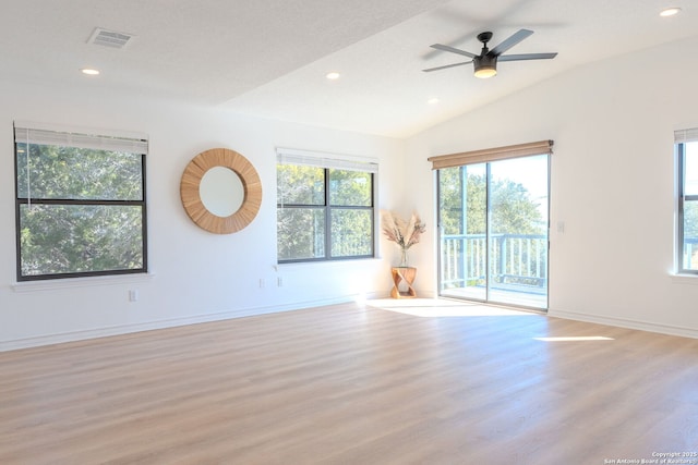 empty room with ceiling fan, light hardwood / wood-style flooring, and lofted ceiling