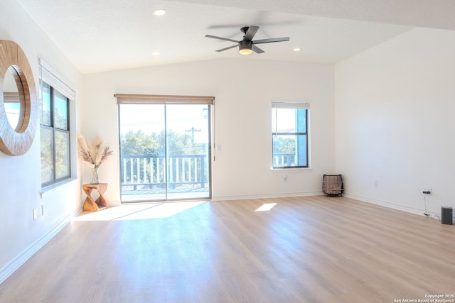 empty room featuring vaulted ceiling, ceiling fan, light hardwood / wood-style floors, and a textured ceiling