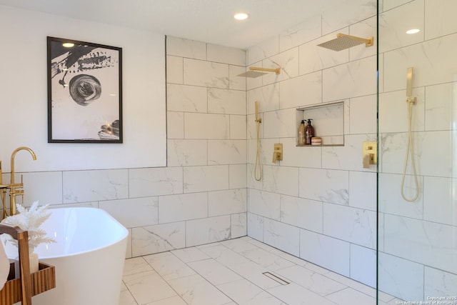 bathroom featuring shower with separate bathtub