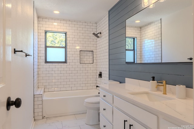 full bathroom with tiled shower / bath combo, toilet, and vanity