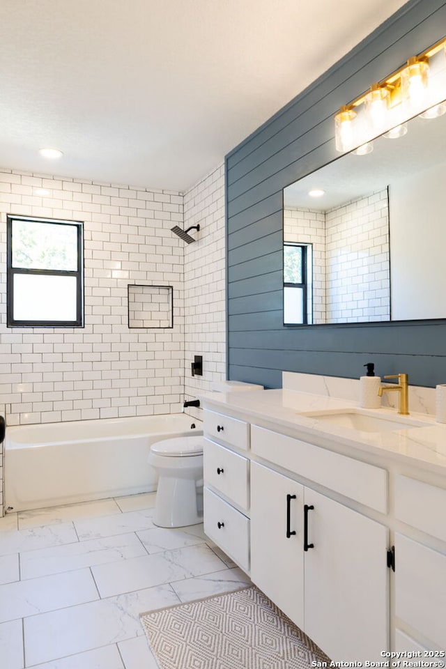 full bathroom featuring vanity, toilet, and tiled shower / bath