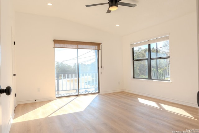 spare room featuring vaulted ceiling, ceiling fan, and light hardwood / wood-style flooring