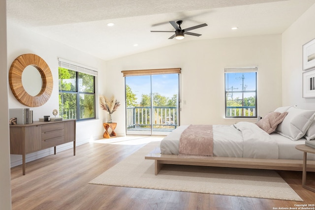 bedroom with ceiling fan, access to exterior, multiple windows, and light hardwood / wood-style flooring