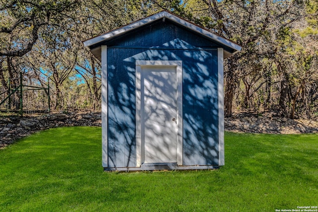 view of outdoor structure featuring a lawn