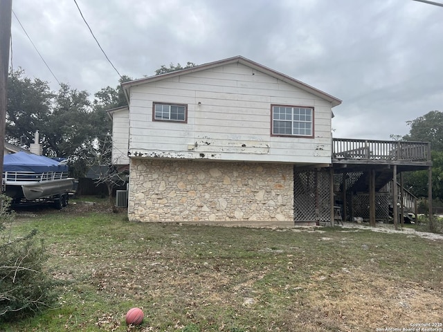 view of home's exterior featuring a yard, cooling unit, and a deck