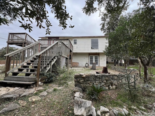 rear view of property with a wooden deck and french doors