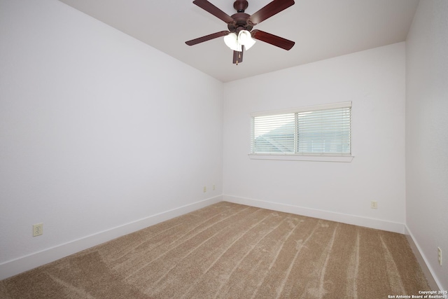 carpeted spare room with ceiling fan