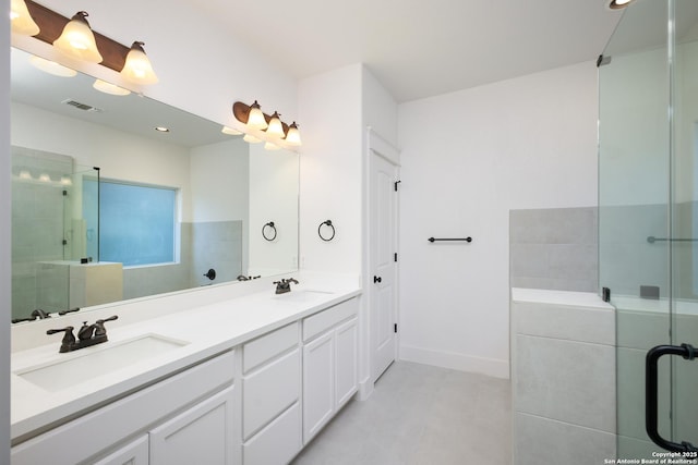 bathroom featuring an enclosed shower, vanity, and tile patterned floors