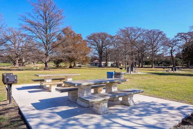 view of home's community with a lawn and a patio area