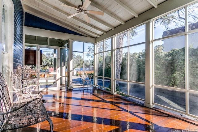 unfurnished sunroom featuring lofted ceiling with beams, a wealth of natural light, ceiling fan, and wood ceiling