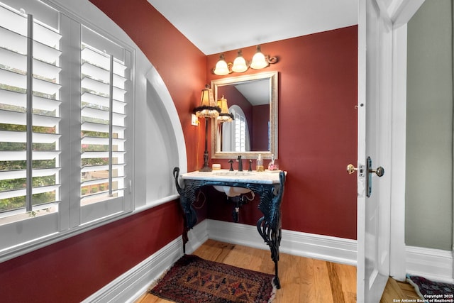 bathroom featuring hardwood / wood-style floors, a healthy amount of sunlight, and vanity