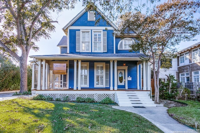 view of front of property with a porch and a front yard