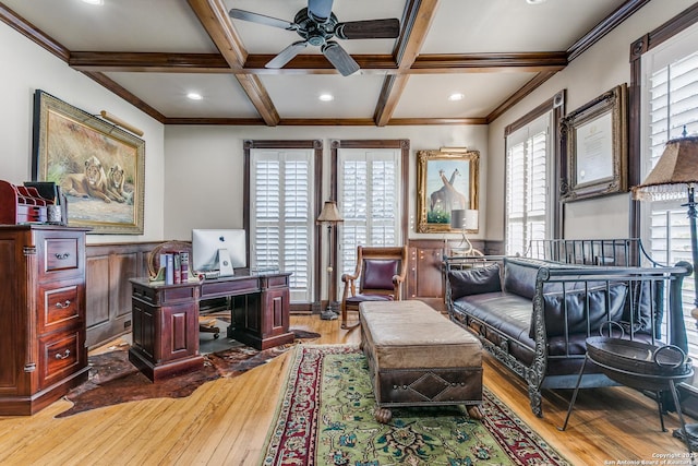 home office featuring beamed ceiling, crown molding, coffered ceiling, light hardwood / wood-style flooring, and ceiling fan