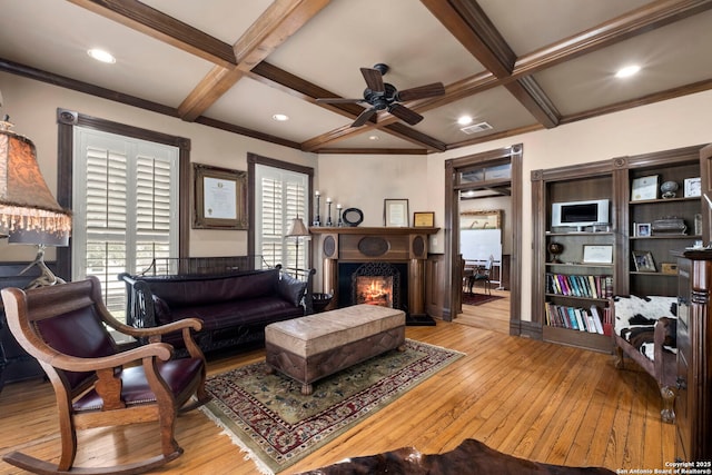 living room with light wood-type flooring, beam ceiling, and coffered ceiling