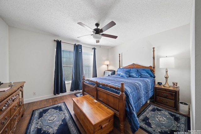 bedroom featuring ceiling fan, hardwood / wood-style floors, and a textured ceiling