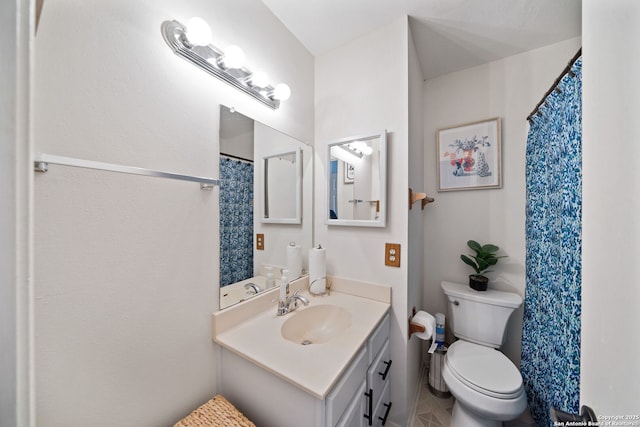 bathroom featuring toilet, tile patterned floors, and vanity