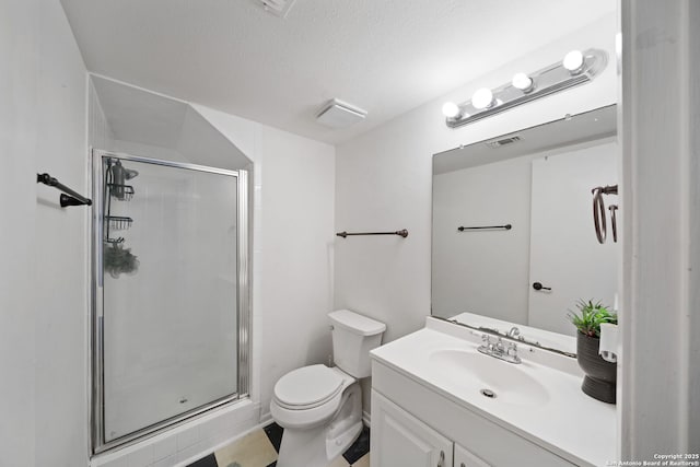 bathroom featuring a shower with shower door, a textured ceiling, toilet, and vanity