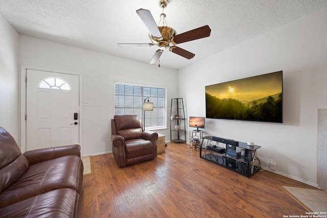 living room featuring ceiling fan, a textured ceiling, hardwood / wood-style floors, and a healthy amount of sunlight