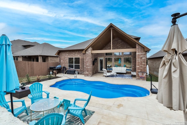 view of pool featuring an outdoor living space and a patio area