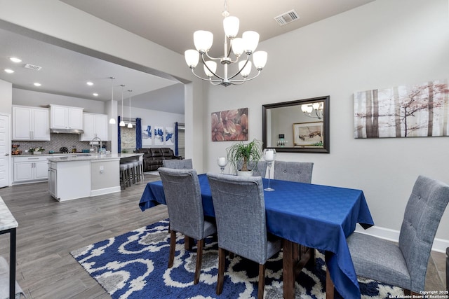 dining room featuring an inviting chandelier and dark hardwood / wood-style floors