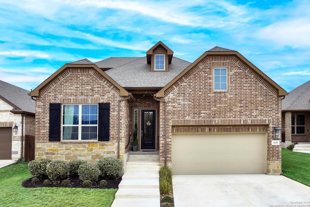 view of front of house featuring a garage and a front yard