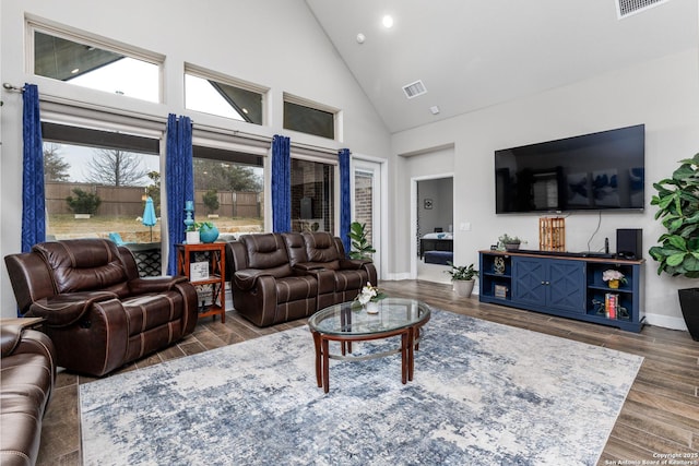 living room featuring high vaulted ceiling and dark hardwood / wood-style flooring