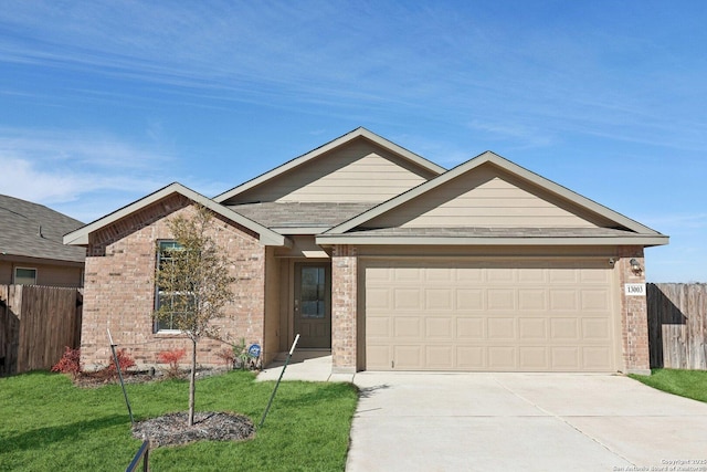 view of front of home with a garage and a front lawn