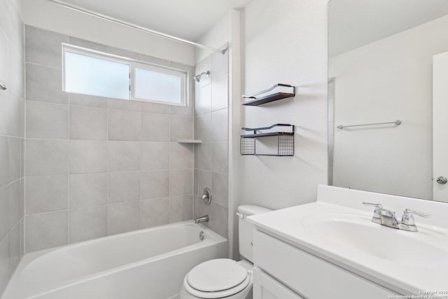 full bathroom with vanity, toilet, and tiled shower / bath