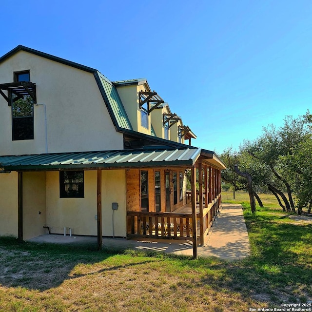 rear view of property with a lawn