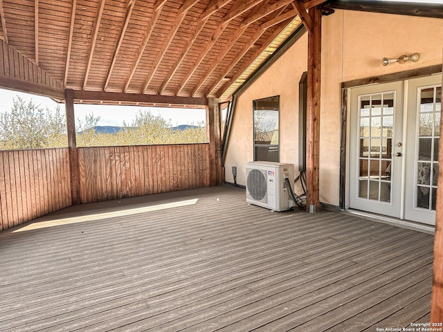 wooden deck featuring ac unit and french doors