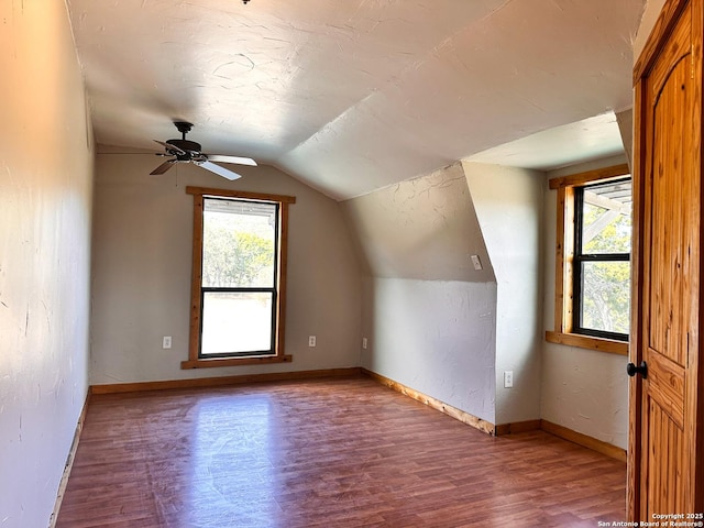 bonus room with hardwood / wood-style flooring, ceiling fan, lofted ceiling, and a wealth of natural light