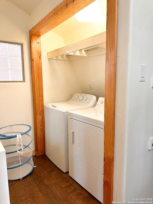 washroom with dark hardwood / wood-style flooring and washer and clothes dryer