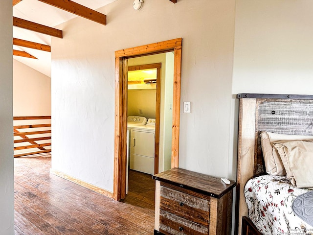 interior space with washer and clothes dryer, vaulted ceiling with beams, and dark hardwood / wood-style floors