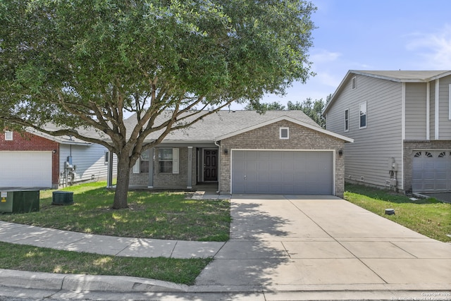 view of front of property featuring cooling unit, a front yard, and a garage