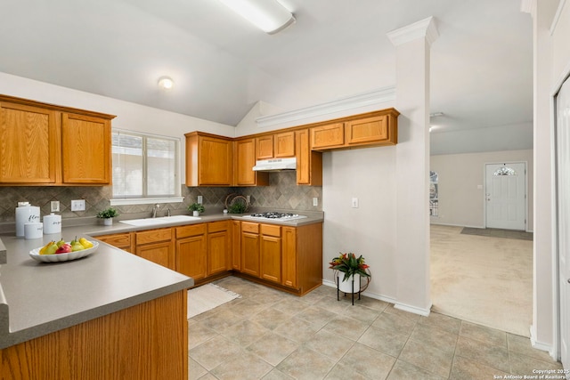 kitchen with white gas cooktop, light carpet, decorative backsplash, sink, and lofted ceiling