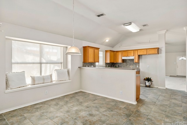 kitchen featuring decorative light fixtures, decorative backsplash, kitchen peninsula, and vaulted ceiling