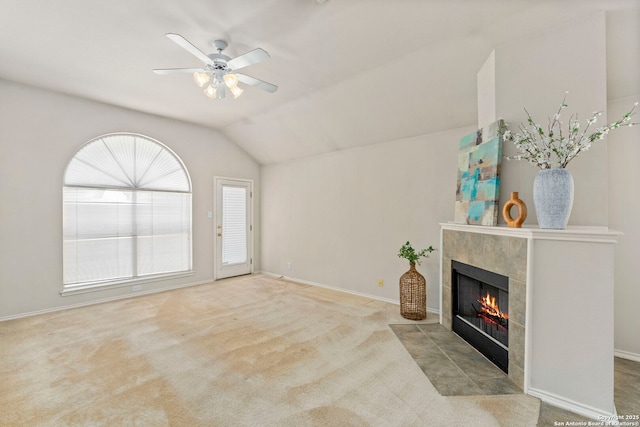 living room with light carpet, ceiling fan, a fireplace, and lofted ceiling