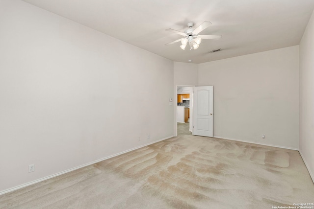 carpeted spare room with ceiling fan