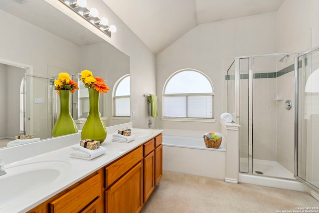 bathroom featuring vanity, independent shower and bath, and vaulted ceiling