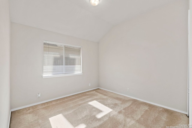 empty room with light carpet and lofted ceiling