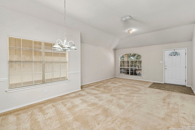 interior space featuring a notable chandelier and vaulted ceiling