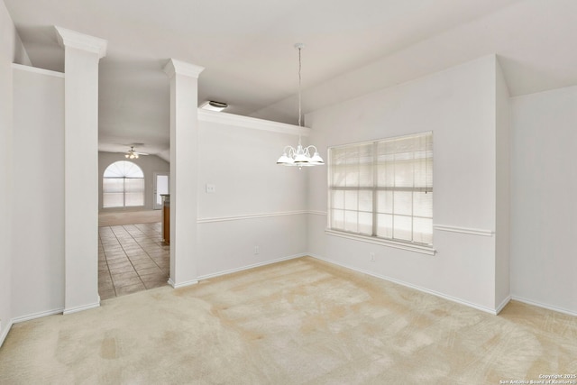 carpeted spare room with ceiling fan with notable chandelier and lofted ceiling