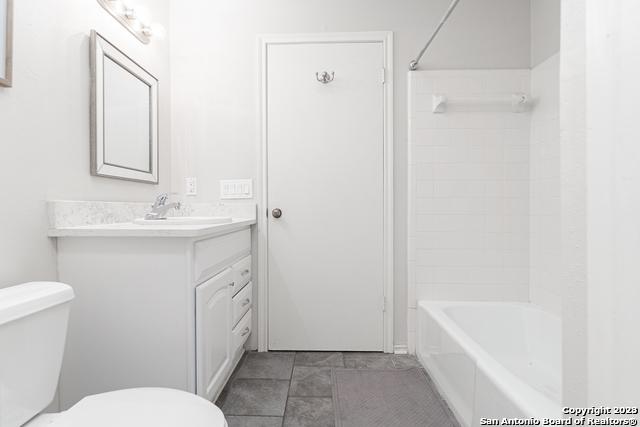 full bathroom with shower / bath combination, toilet, tile patterned floors, and vanity